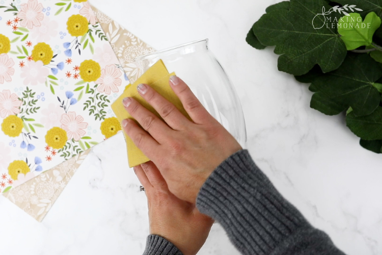 Womans hands cleaning glass vase