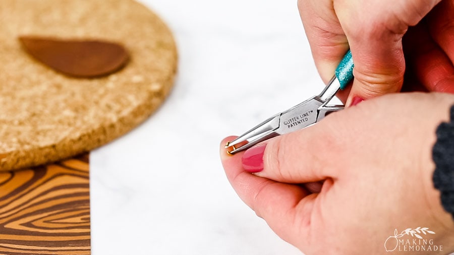 Using needle-nose pliers to open jump rings for DIY earrings