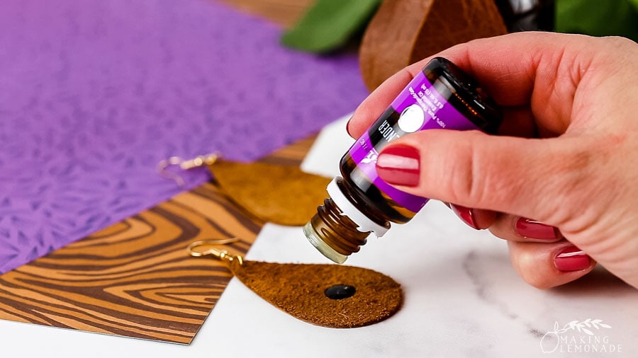 Adding a few drops of essential oil to leather teardrop earrings