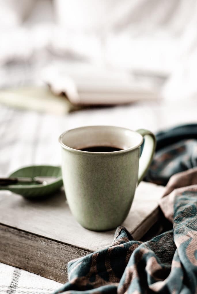 coffee and book on bed