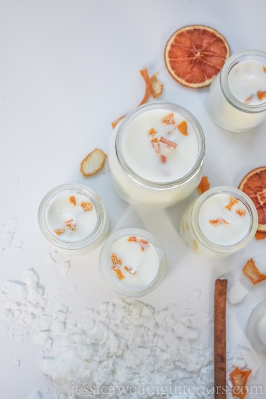 homemade soy candles in glass jars with dried oranges