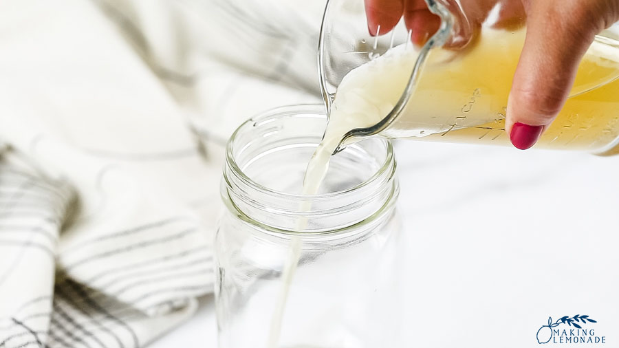 apple cider vinegar being poured into jar