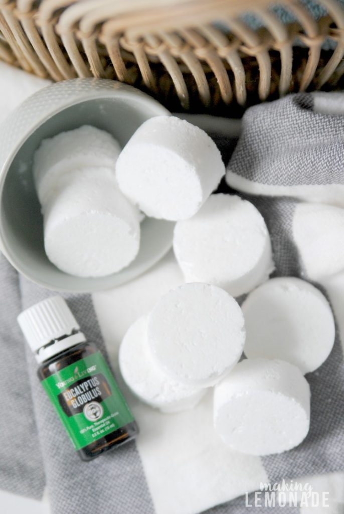 A bunch of DIY shower steamers with a bottle of Eucalyptus essential oil