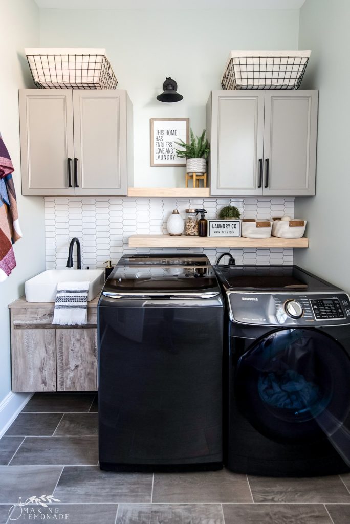 small laundry room with cabinets