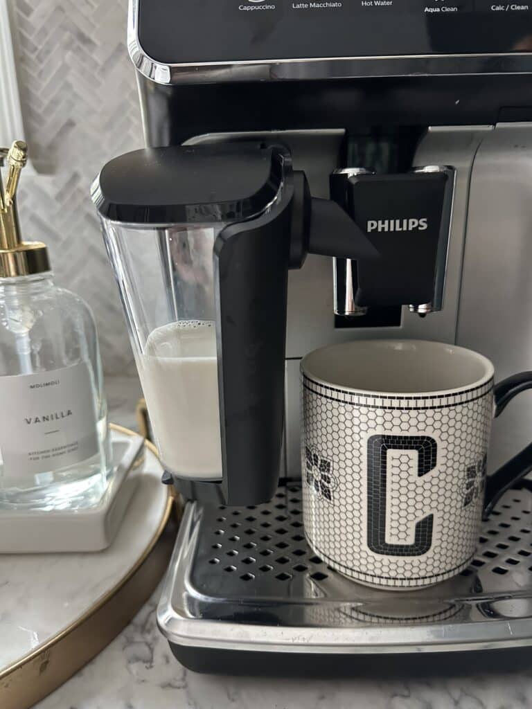 Phillips LatteGo espresso machine with mug and syrups
