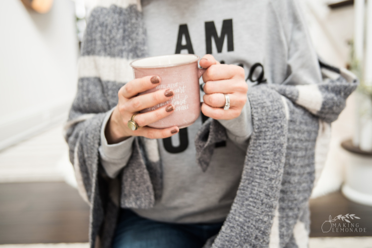 woman holding pink mug