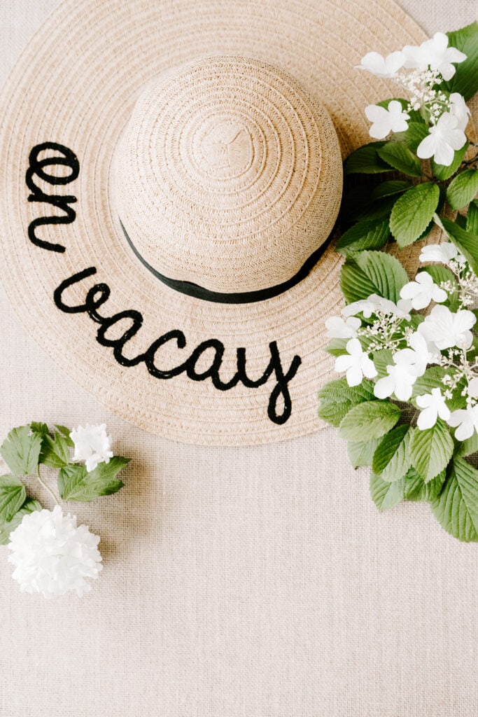 beach hat that says 'on vacay' with flowers